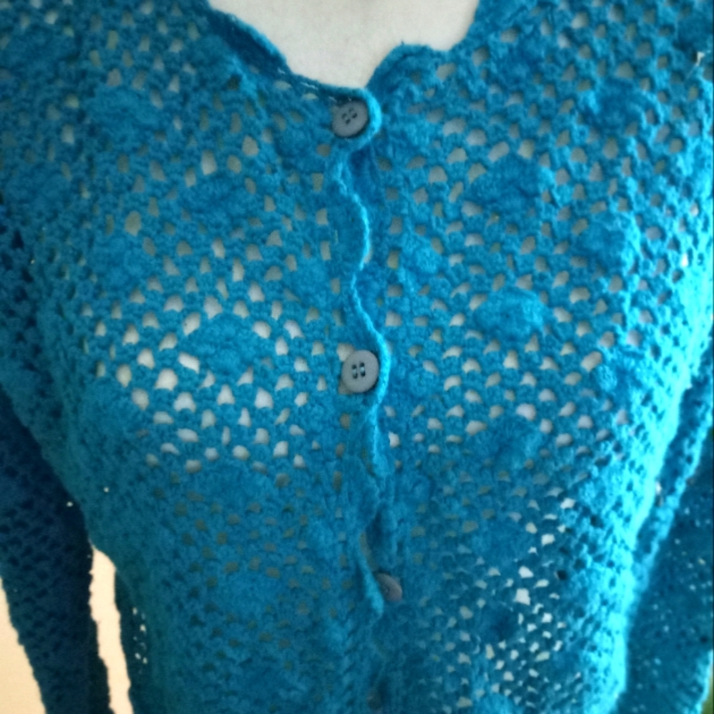 Used not new never worn crocheted cropped to waist turquoise cardigan sweater.
